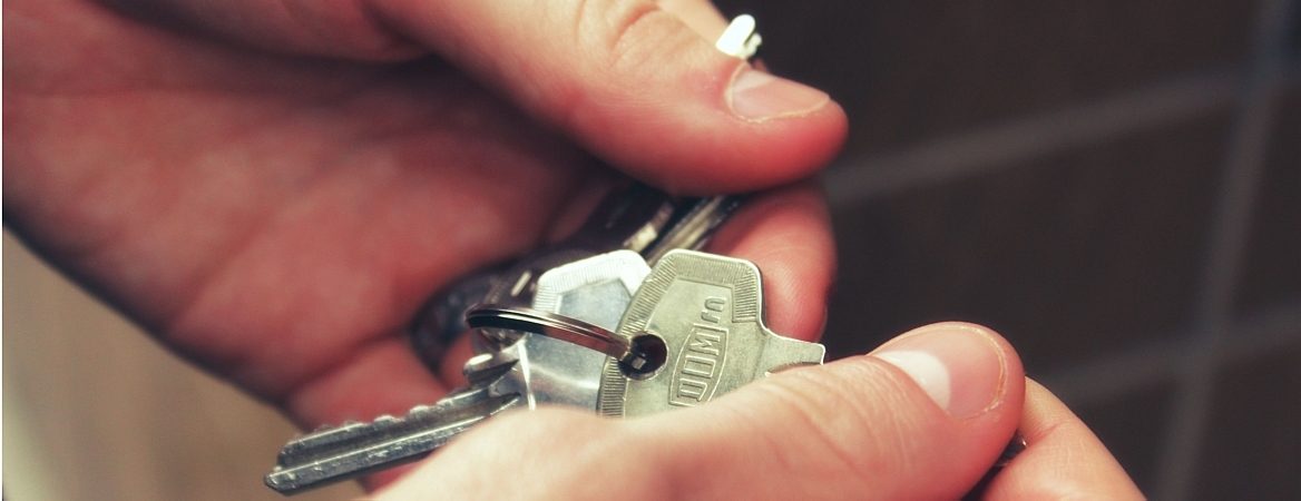 Jovem segura chaves do apartamento. Imagem faz close apenas nas mãos da pessoa